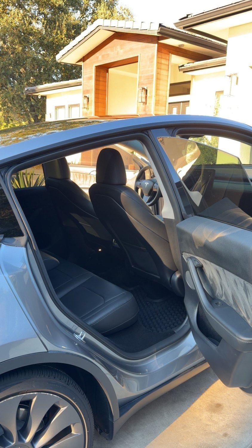 Detailed Tesla rear seating and floor mats